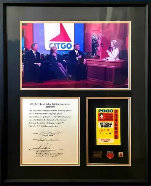 Framed memorabilia featuring a photo of the 2003 Jerry Lewis MDA Telethon with Citgo branding, an official appearance agreement, and a "National Sponsor" pass.